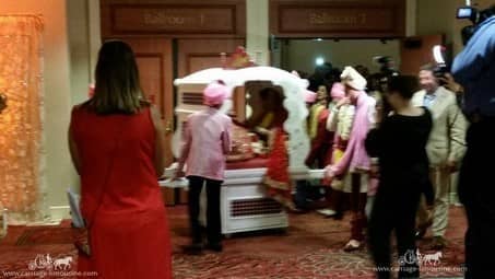 The bride getting rolled out in our Indian wedding Doli